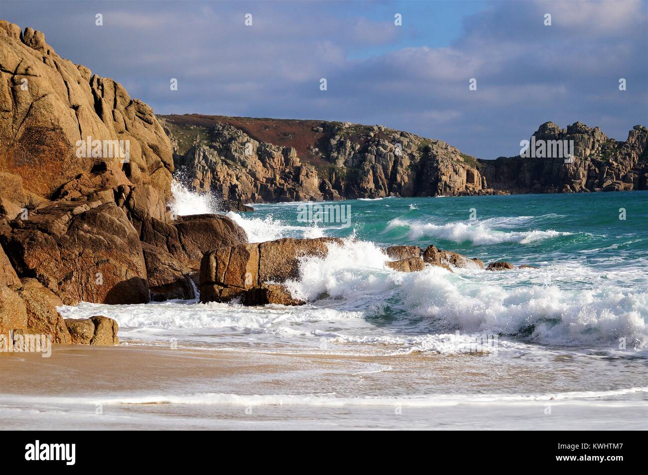 Crashing waves against the shore line at Porthcurno beach Stock Photo