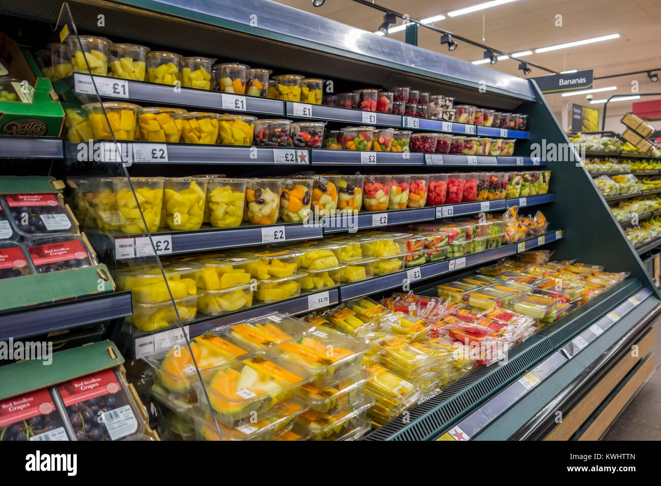 Prepared packaged fruit on supermarket shelves. Stock Photo