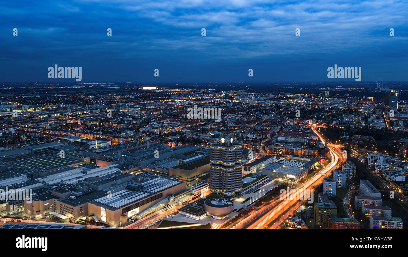Munich, Germany - December 14, 2016: Evening Munich birds eye panoramic cityscape view with bright night lights of BMW plant and headquarters Stock Photo