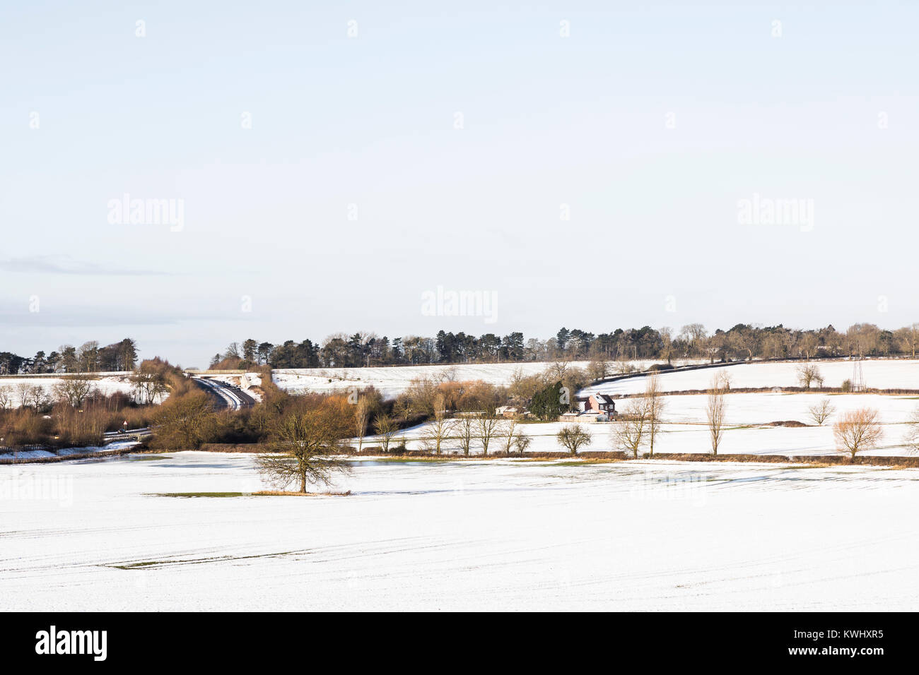 An image of a farm cottage situated in a snow covered landscape shot