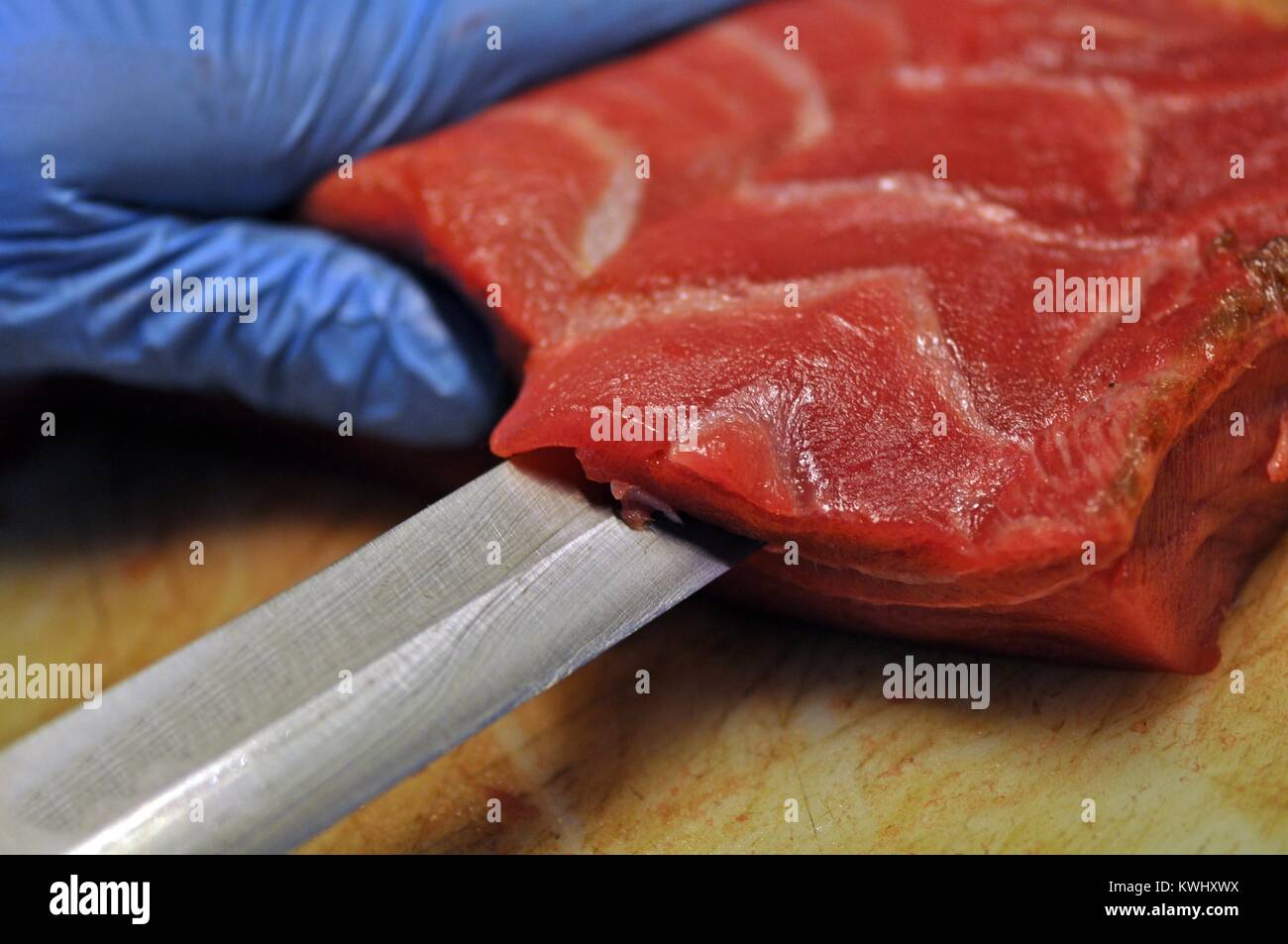 Chef cutting fresh red tuna, with Japanese Knife Stock Photo