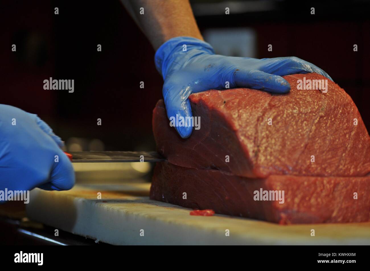 Chef cutting fresh red tuna, with Japanese Knife Stock Photo