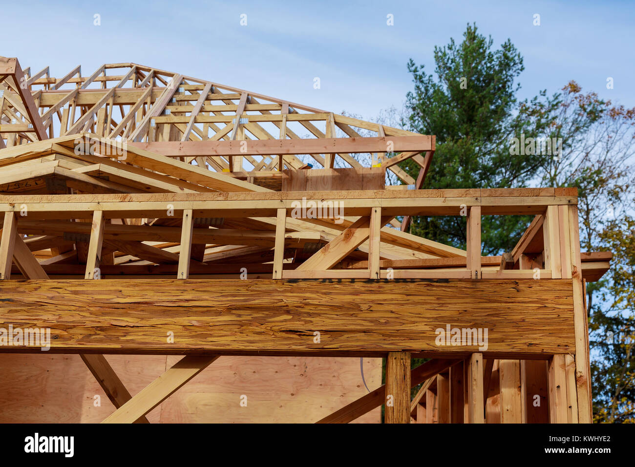 New build roof with wooden truss, post and beam framework. New home construction framing Timber frame house, real estate. Stock Photo