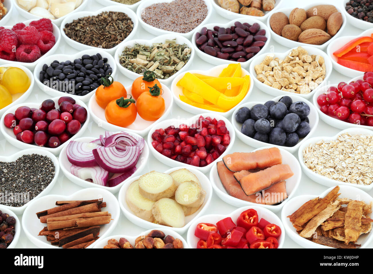 Super food nutrition for a healthy heart with fresh fruit, vegetables, fish, cereals, seeds, nuts. spice and herbal medicine. Stock Photo