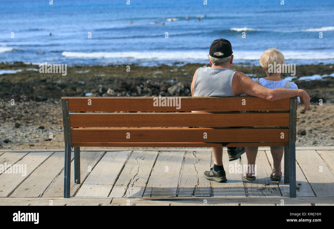 couple seeing the sea in a bench Stock Photo - Alamy