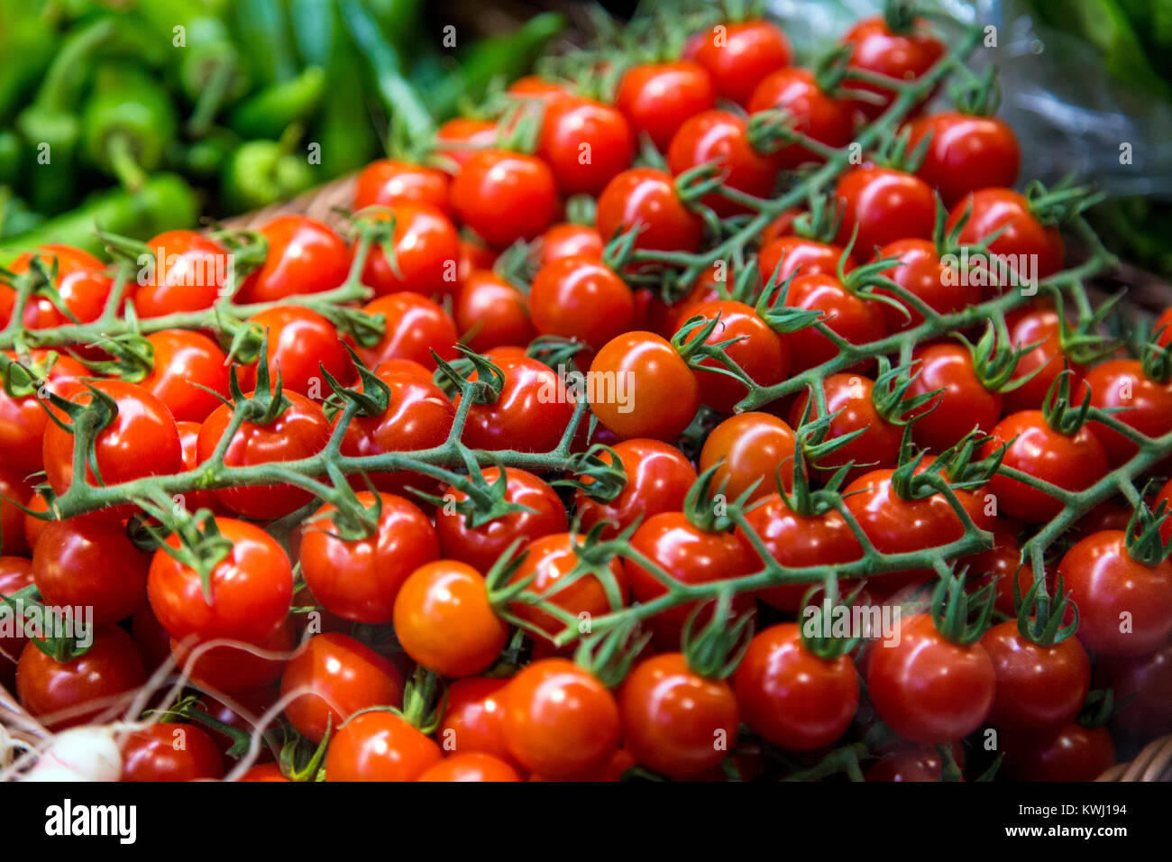 Fresh juicy vine tomatoes for sale at a market Stock Photo