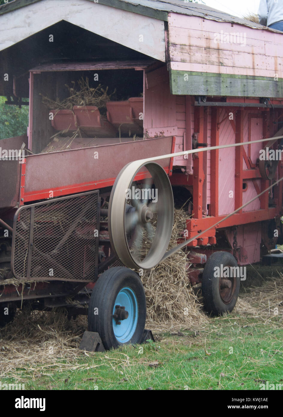 Old threshing machine being used at rural show Stock Photo