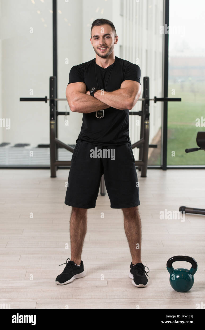 Handsome Personal Trainer With Stopwatch In A Fitness Center Gym