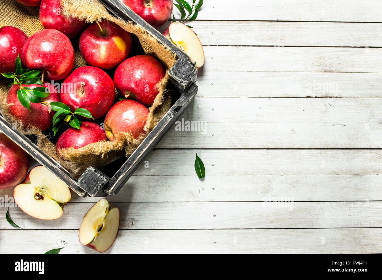 Red apples in a box. On a white wooden background Stock Photo - Alamy