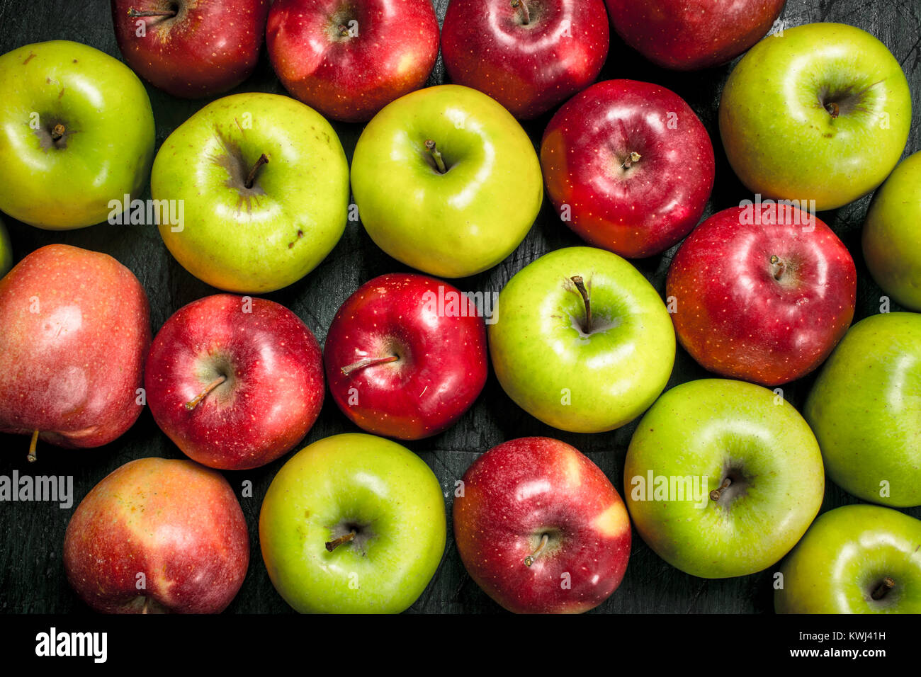 Red and green apples. On a rustic background Stock Photo - Alamy