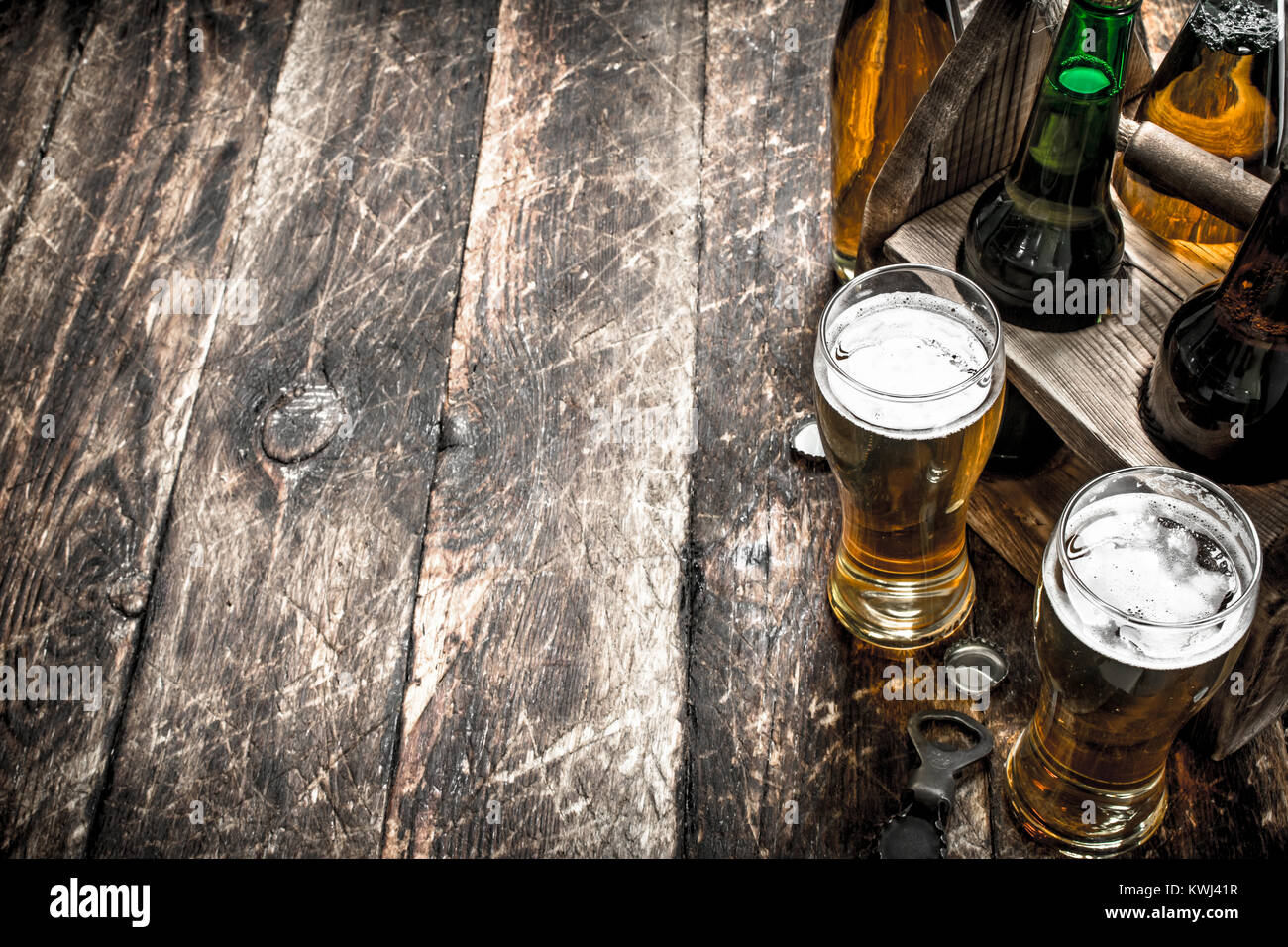 Beer in a box with glasses. On a wooden background Stock Photo - Alamy