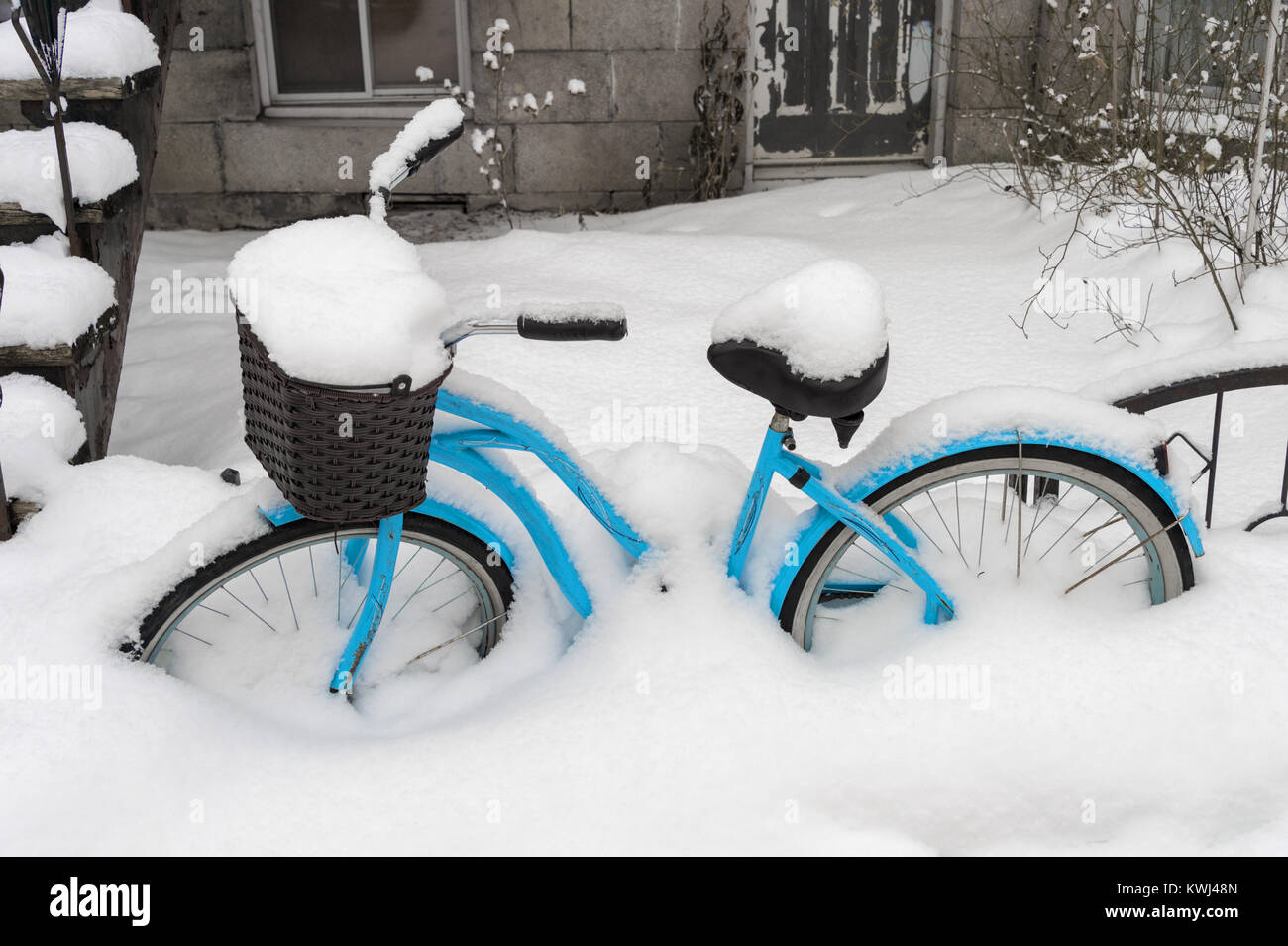 Blue bike covered in snow after snow storm in Montreal Stock Photo - Alamy