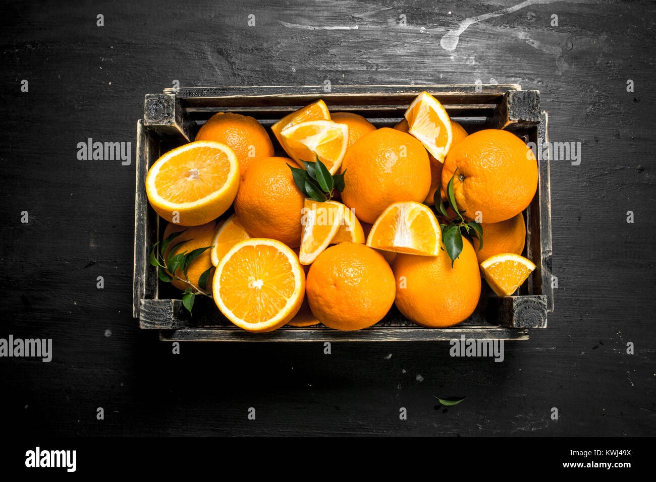 Fresh oranges in an old box. On the black chalkboard Stock Photo - Alamy
