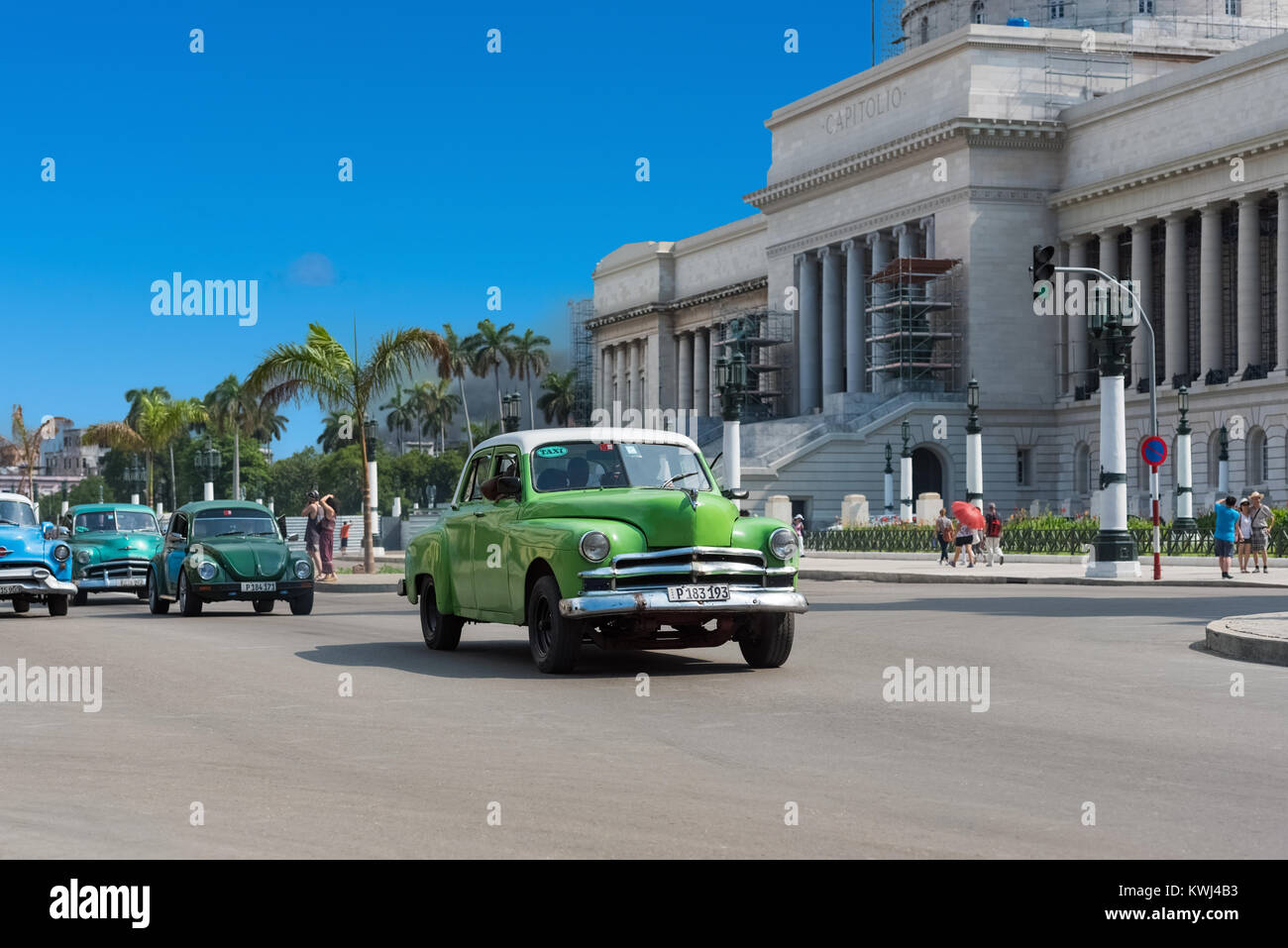 American green Dodge classic car with a white roof drive before the Capitolio on the main street in Havana City Cuba - Serie Cuba Reportage Stock Photo
