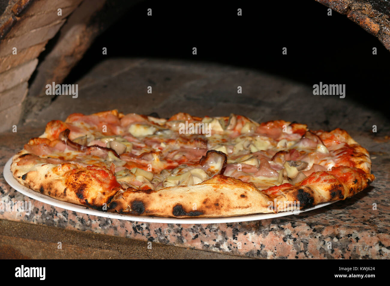 delicious pizza and brick oven close up Stock Photo