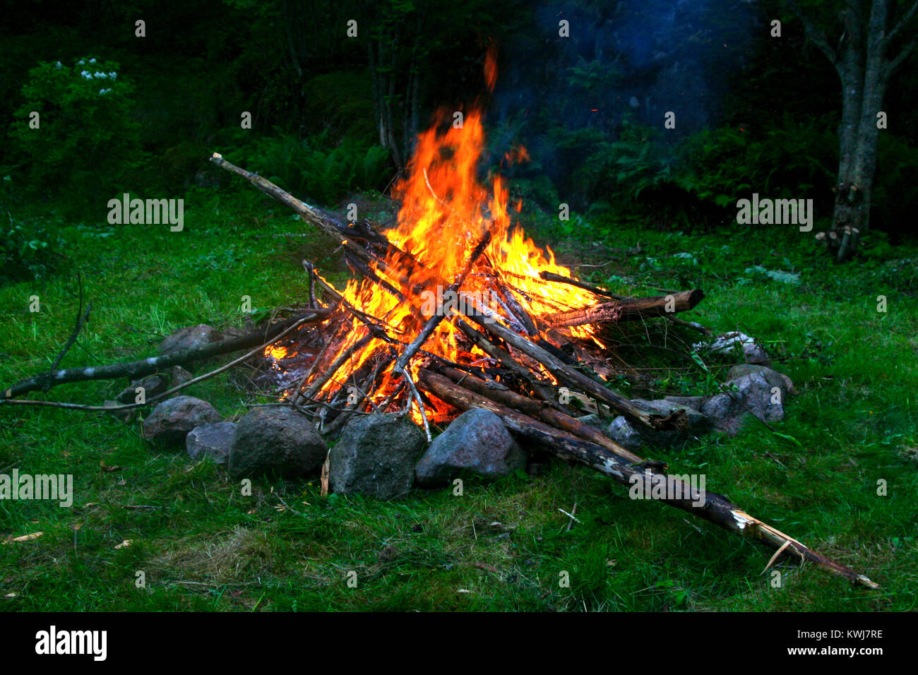 Bonfire - Celebrating Midsummer at camping site Stock Photo