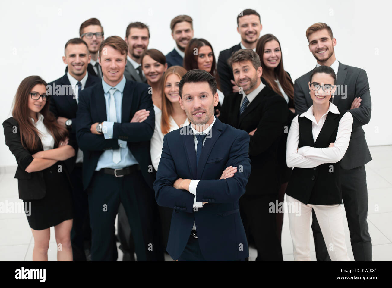 leader standing in front of a large business team Stock Photo - Alamy