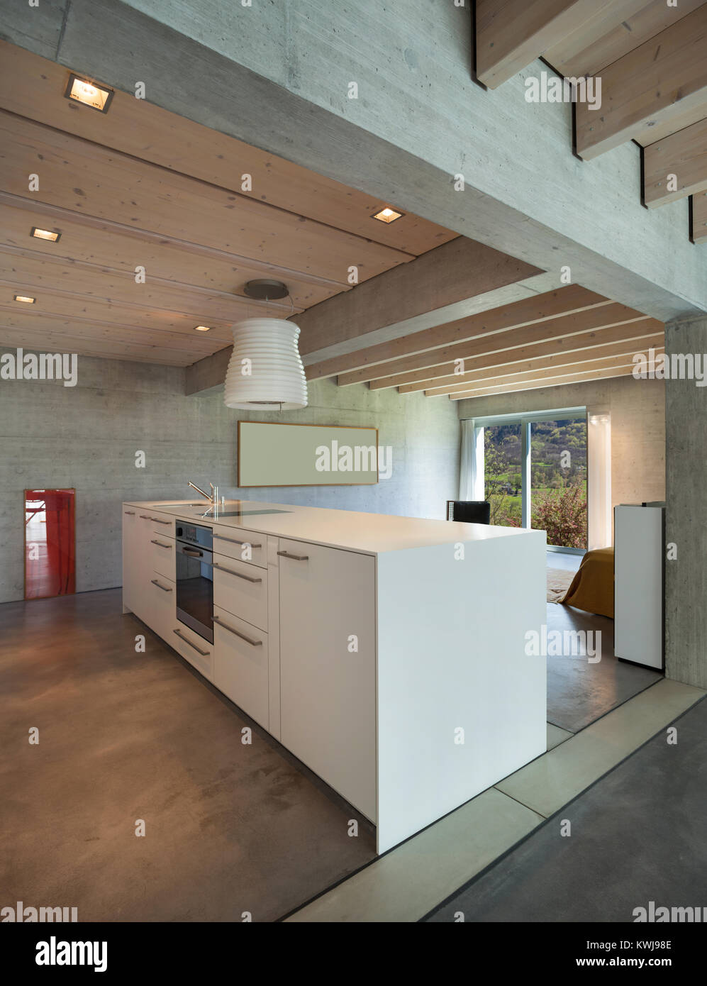 Interior of a modern chalet in cement, white kitchen island Stock Photo