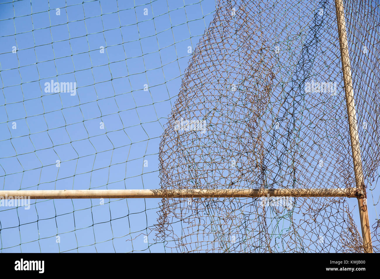 damage wire mesh steel on blue sky background Stock Photo