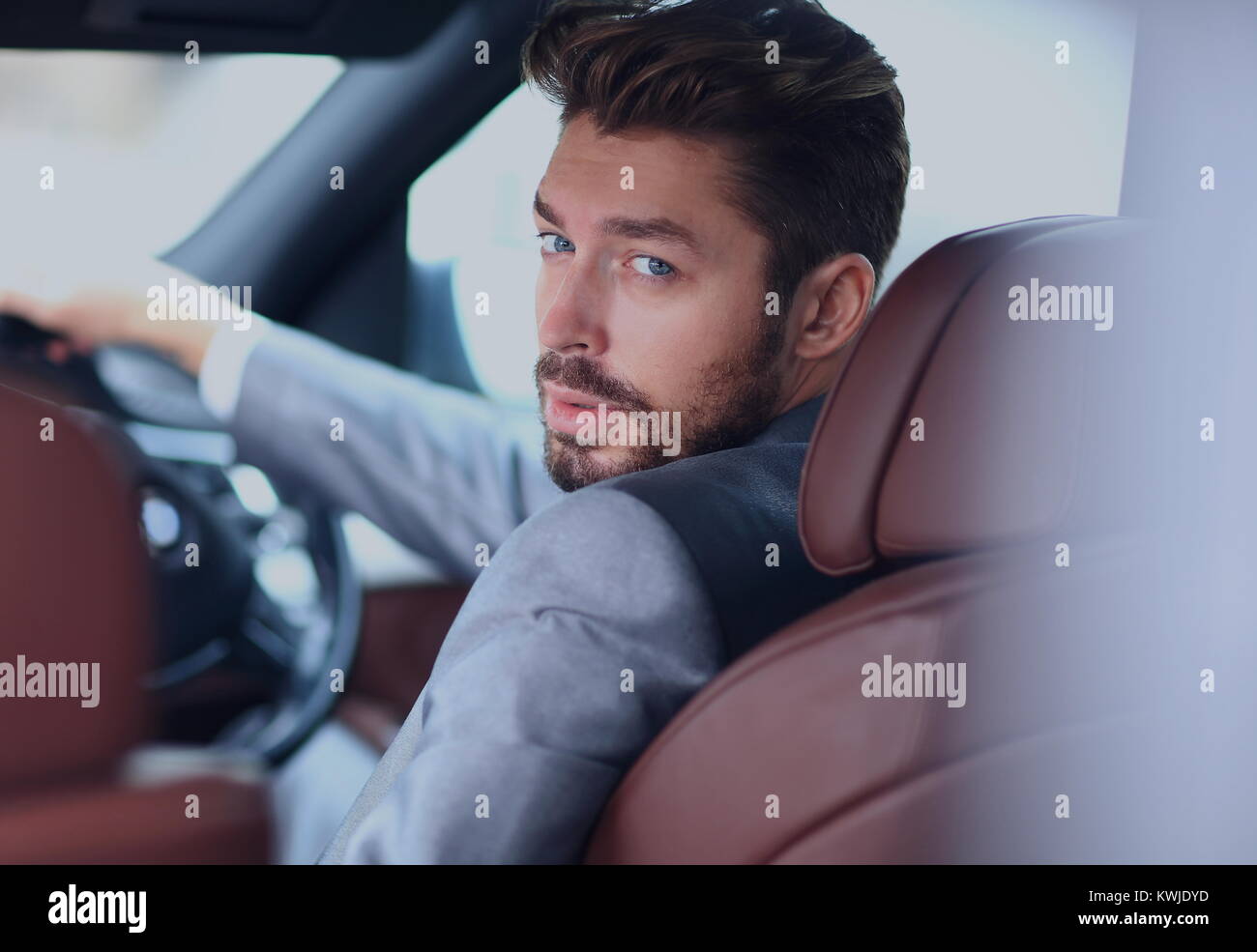 Portrait of an handsome smiling business man driving his car Stock ...