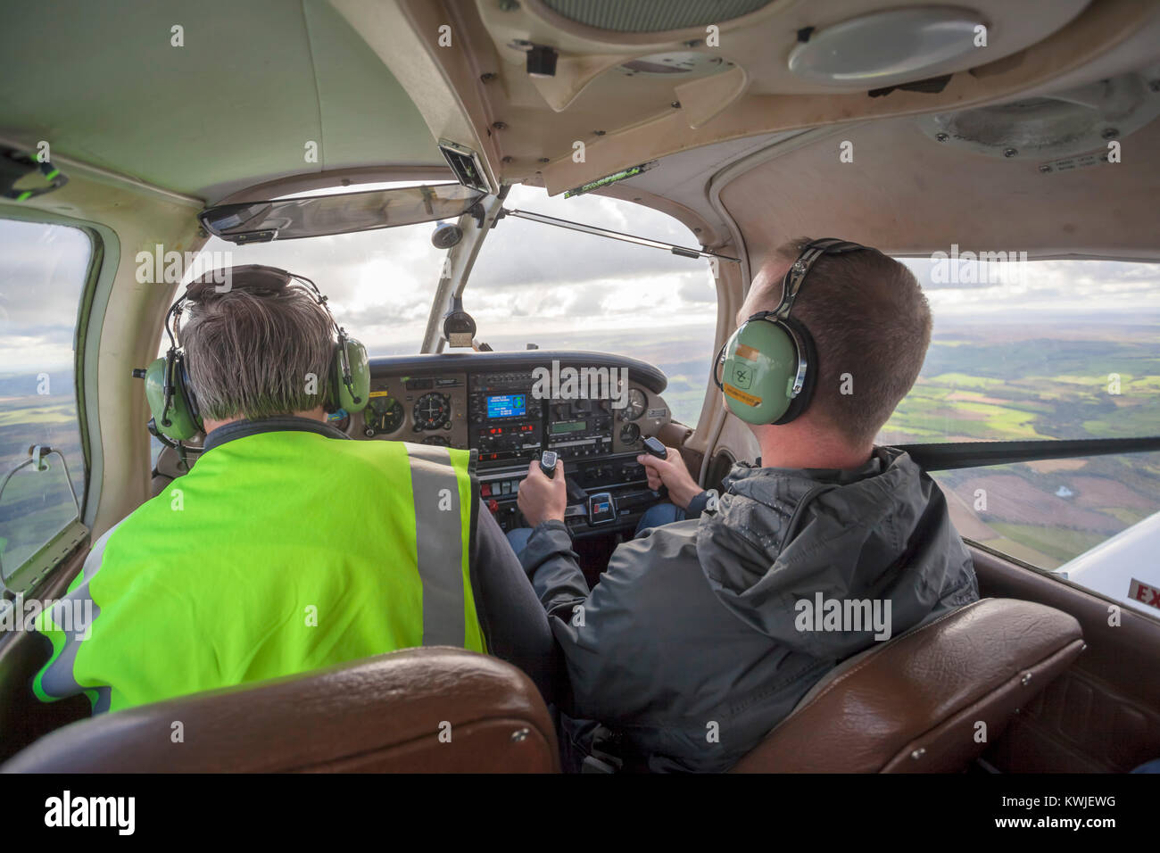Pilot and co pilot flying in a Piper PA28 Cherokee light aircraft out