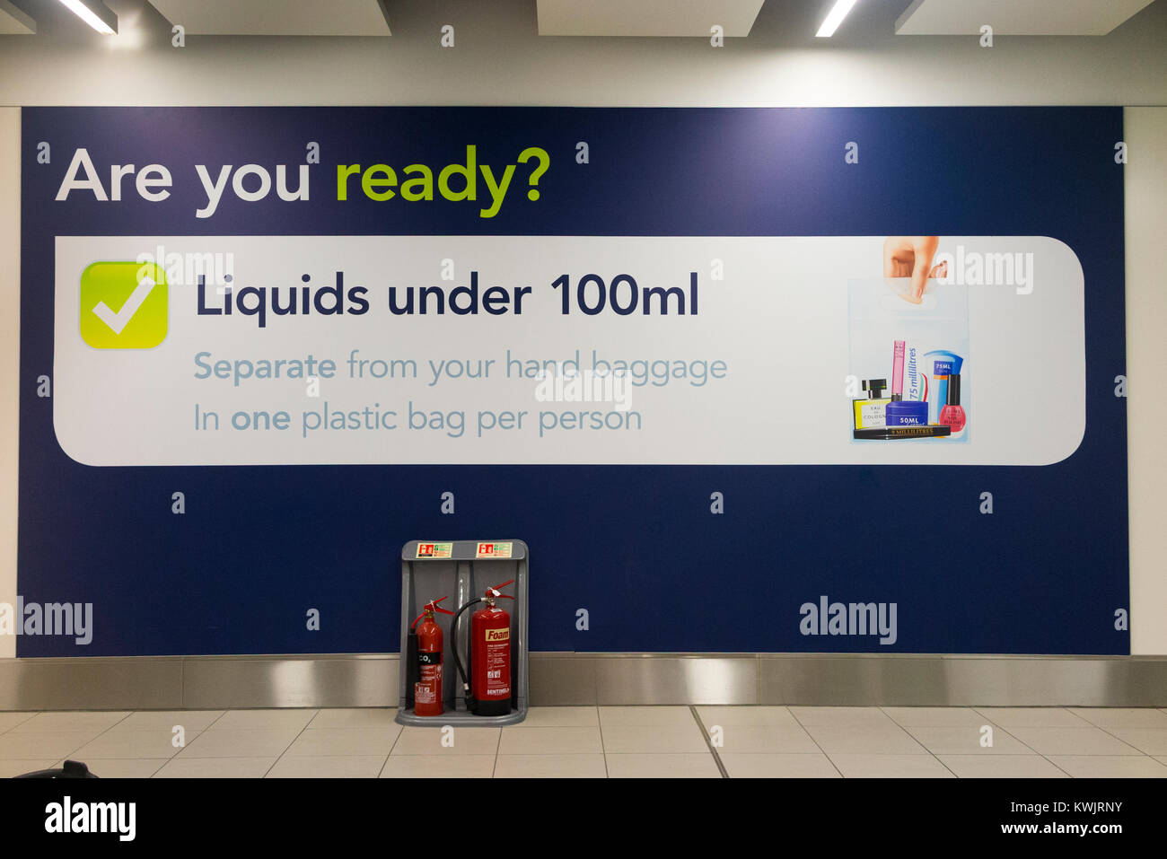 Warning sign regarding the rules on carrying no more than 100 ml of liquid in passenger hand luggage at security check, London Gatwick airport. UK. Stock Photo