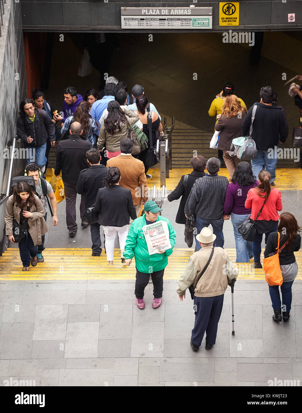 Santiago de Chile, Chile - October 24, 2013: People pass woman advertising La Segunda, Chilean afternoon daily newspaper. Stock Photo