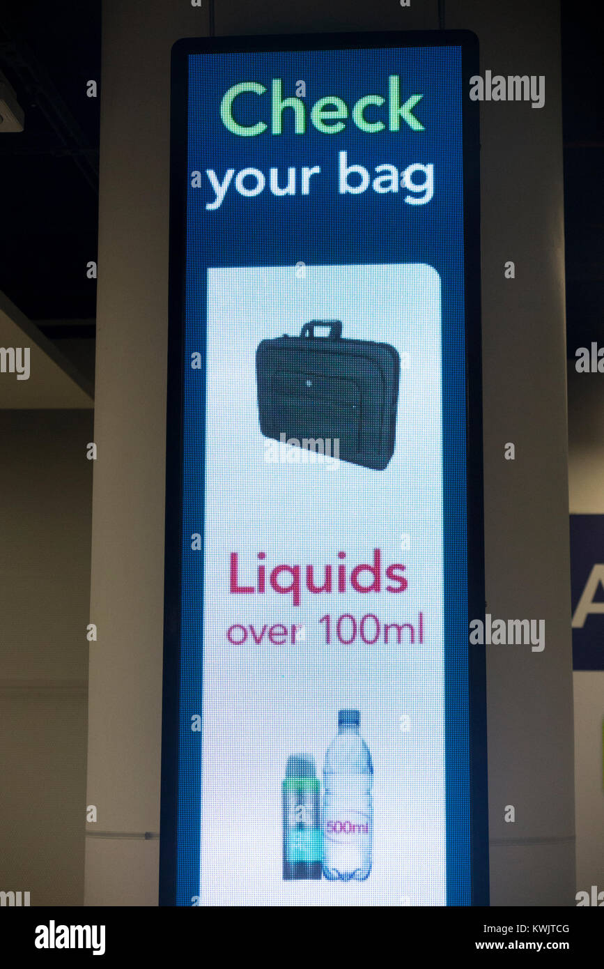 Warning sign regarding the rules on carrying no more than 100 ml of liquid  in passenger hand luggage at security check, London Gatwick airport. UK  Stock Photo - Alamy