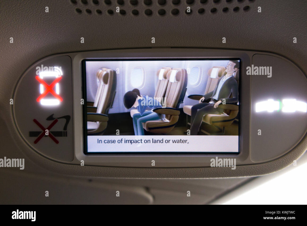 Recorded screening of aeroplane aircraft airplane air plane flight monitor screen showing pre flight passenger safety emergency instructions in plane Stock Photo