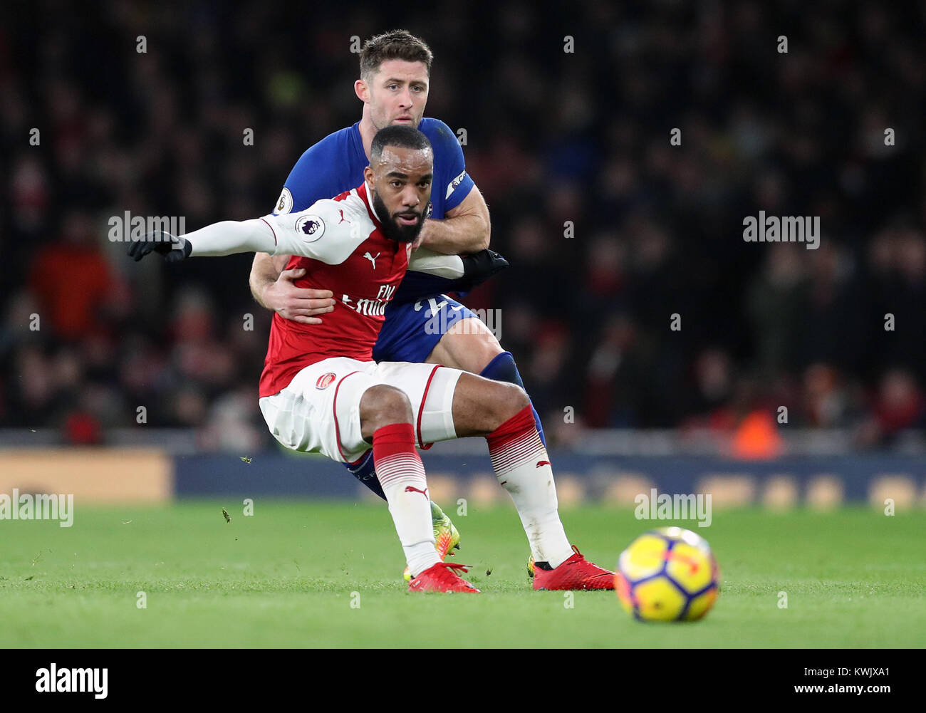 Chelsea's Gary Cahill and Arsenal's Alexandre Lacazette battle for the ball during the Premier League match at the Emirates Stadium, London. PRESS ASSOCIATION Photo. Picture date: Wednesday January 3, 2018. See PA story SOCCER Arsenal. Photo credit should read: Adam Davy/PA Wire. RESTRICTIONS: EDITORIAL USE ONLY No use with unauthorised audio, video, data, fixture lists, club/league logos or 'live' services. Online in-match use limited to 75 images, no video emulation. No use in betting, games or single club/league/player publications. Stock Photo