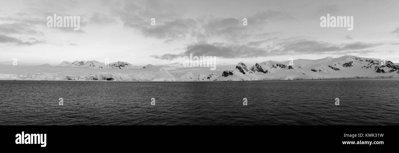 Black & white panorama dusk view of snow & ice covered Antarctica landscape Stock Photo