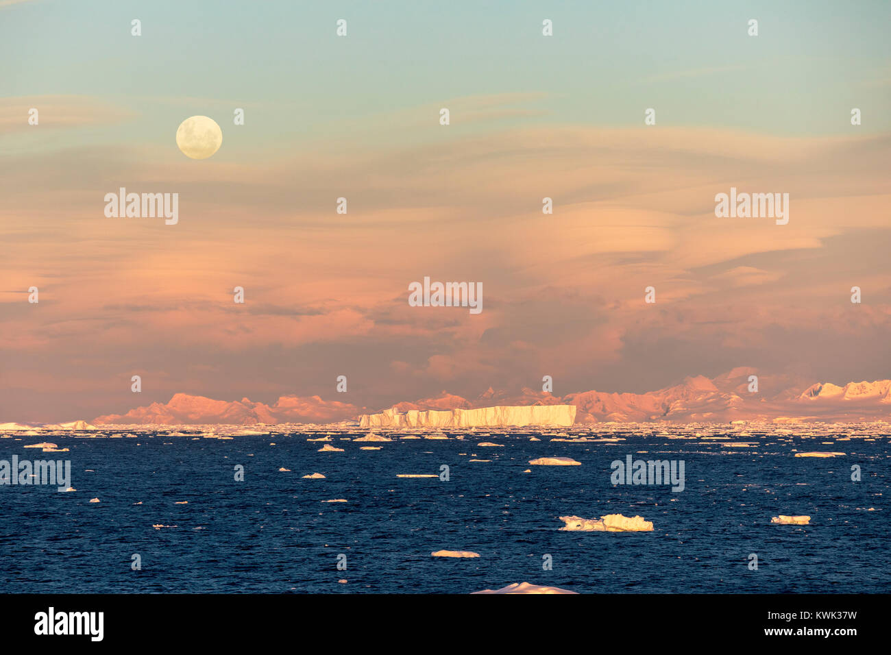 Full moon rising over Antarctica landscape; Rongé Island; Arctowski Peninsula Stock Photo