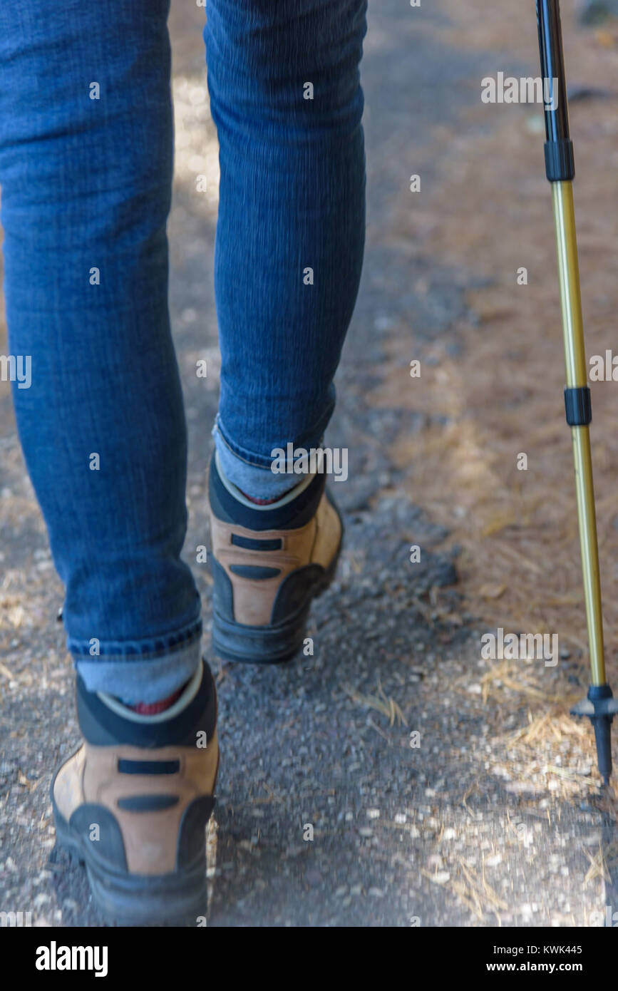 woman wearing hiking boots hiking on paved trail at Devil's Lake State