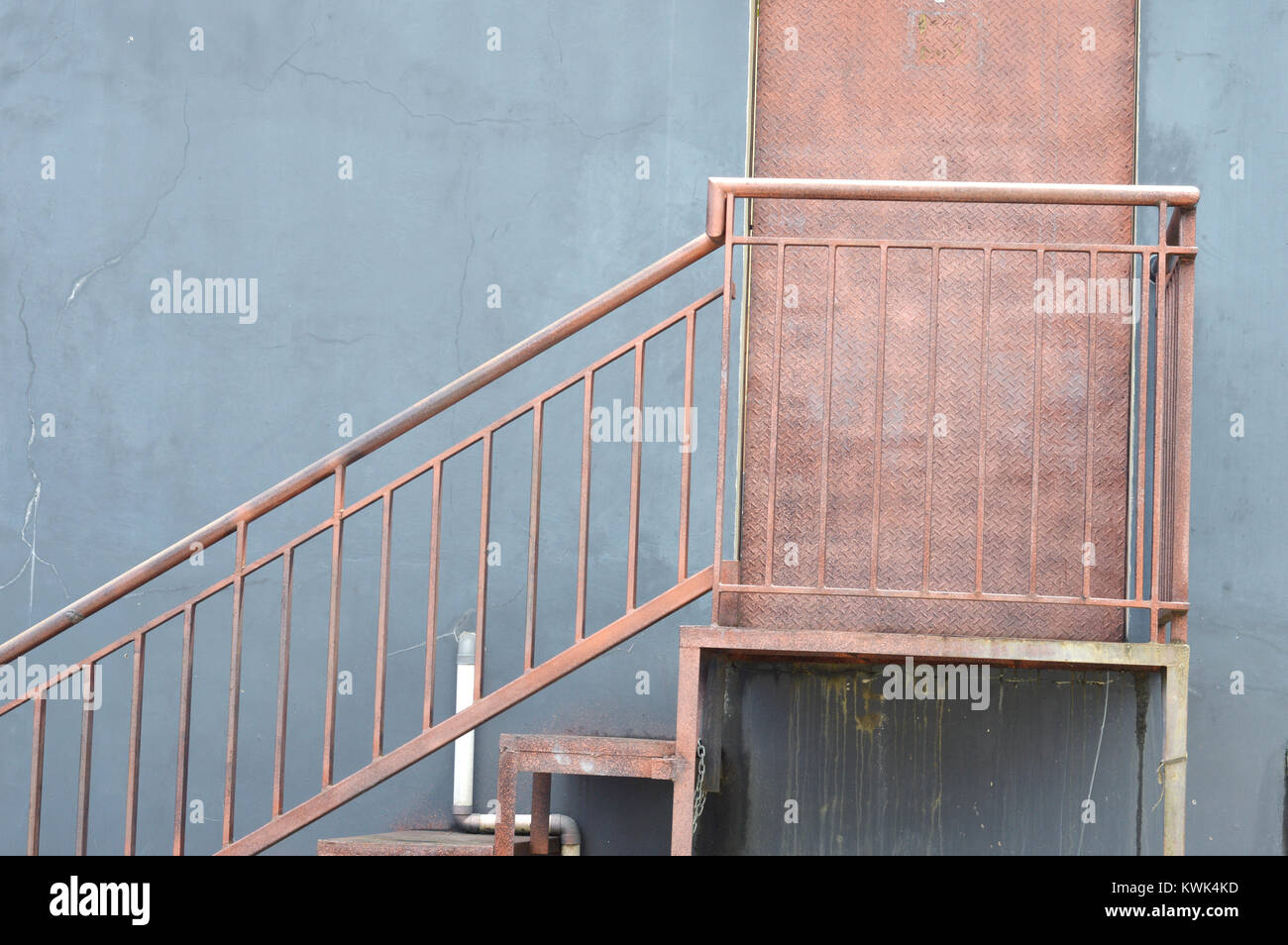 iron door with stairs at the rear of the building Stock Photo Alamy