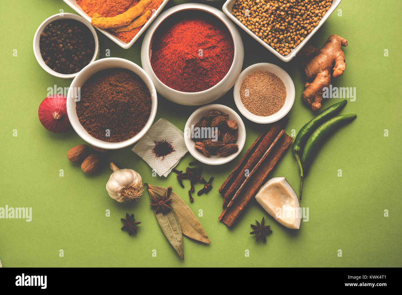 Raw Indian Spice Powder over red, green or yellow background, selective focus Stock Photo