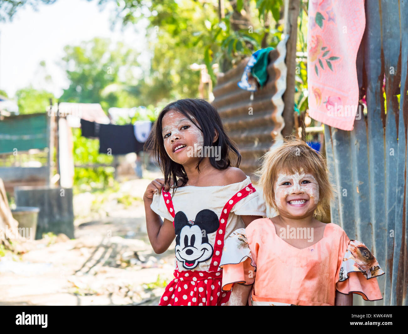 Two cute girls at a rural village in Dala Township near Yangon in Myanmar, both of them with tanaka, the traditional Burmese protective paste applied  Stock Photo