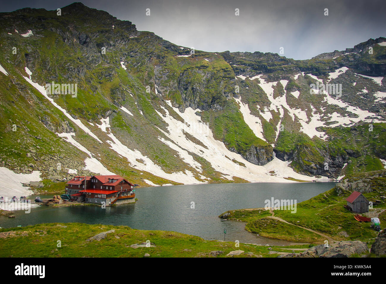 Panoramic view of Balea Lake and cabin with Fagaras Mountains background Stock Photo
