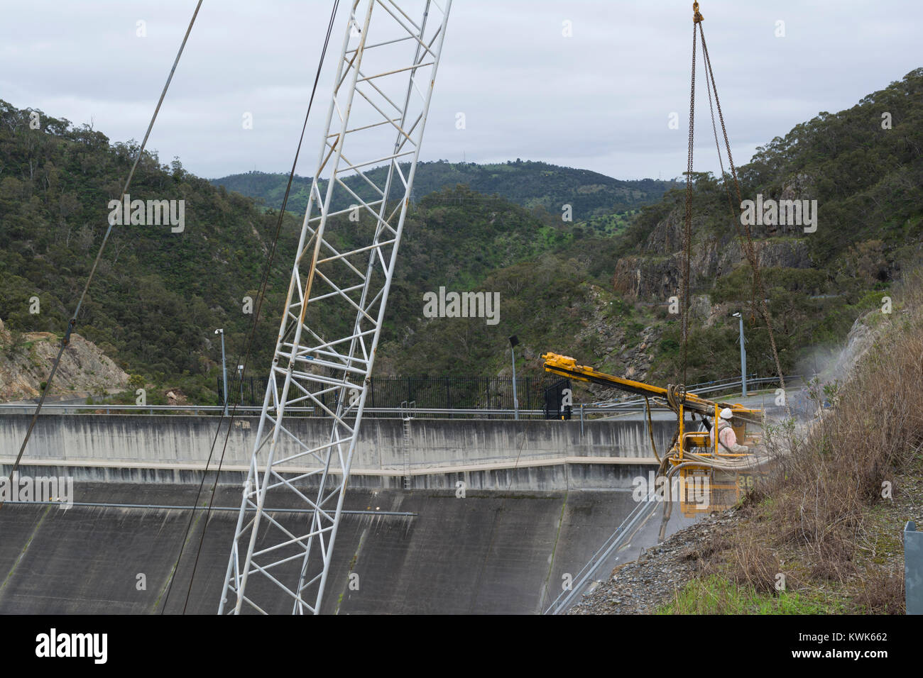 Adelaide Hills, SA, Australia - Sep 10, 2016: Work man in a crane workbox suspended by the crane, working on the the dam upgrade at Kangaroo Creek Res Stock Photo