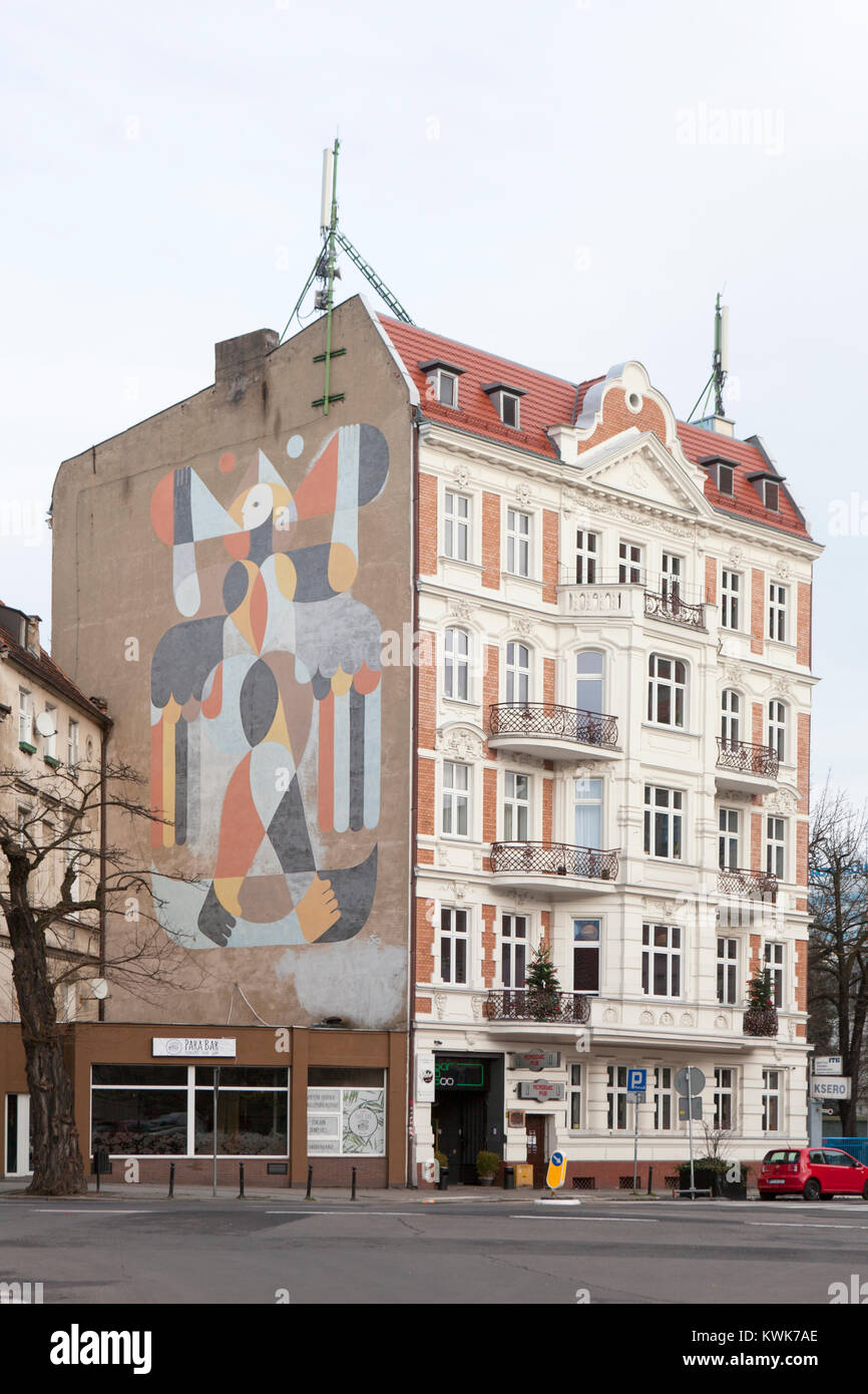 A mural on the side of an old tenement building Poznan Old Town, Stock Photo