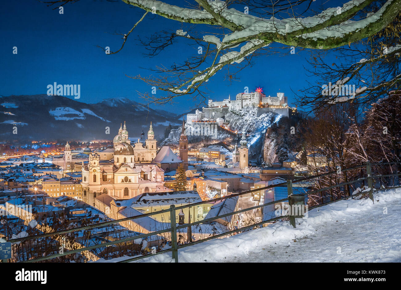 Classic view of the historic city of Salzburg with Salzburg Cathedral and famous Festung Hohensalzburg illuminated in beautiful twilight during Christ Stock Photo