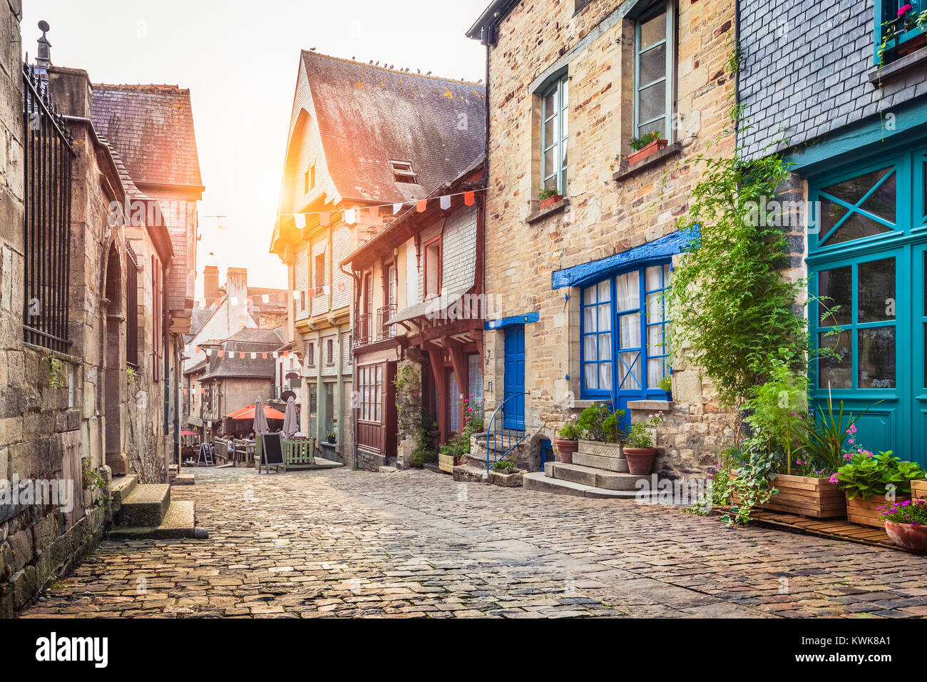 Panoramic view of a charming street scene in an old town in Europe in beautiful evening light at sunset with retro vintage filter effect Stock Photo