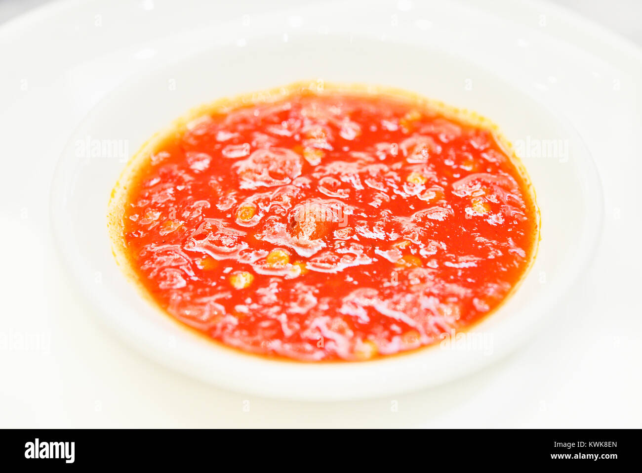 A tray of red chili sauce. This type is commonly eaten with Hainanese chicken rice in Singapore. It can also be served with other regional Asian food. Stock Photo