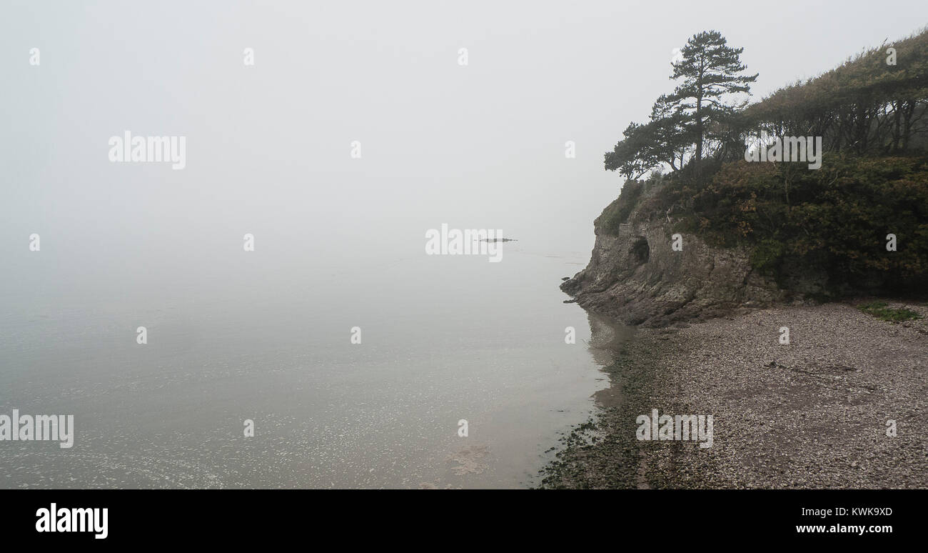 Cave and cliffs in fog, Silverdale, Morecambe Bay, Lancashire UK Stock Photo