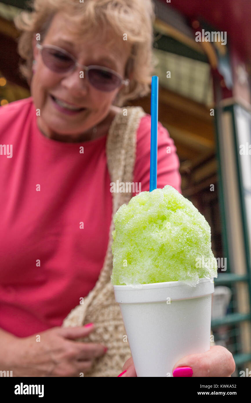 Senior Woman Handing Snow Cone toward Camera, USA Stock Photo