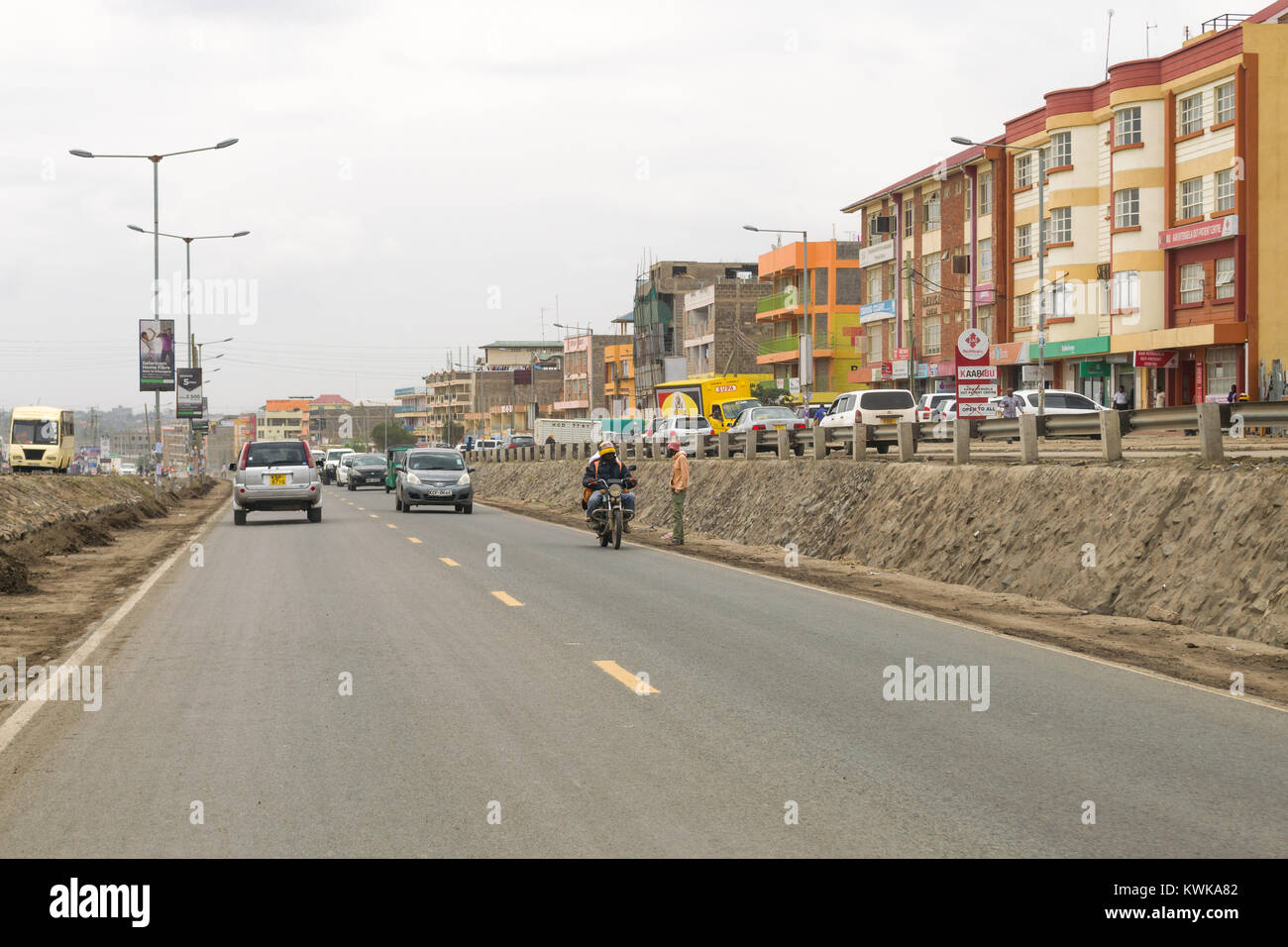 View of the main A104 road through Kitengela town with traffic and buildings, Kenya, East Africa Stock Photo