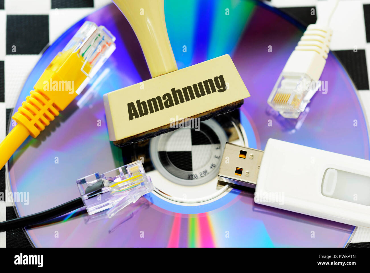 Stamp with label Caution and DVD, Memory kink and Internet cables, caution for unlawful downloads, Stempel mit Aufschrift Abmahnung und DVD, Speichers Stock Photo