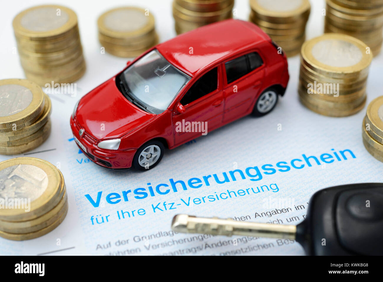 Miniature car and insurance policy, vehicle assurance, Miniaturauto und Versicherungsschein, Kfz-Versicherung Stock Photo