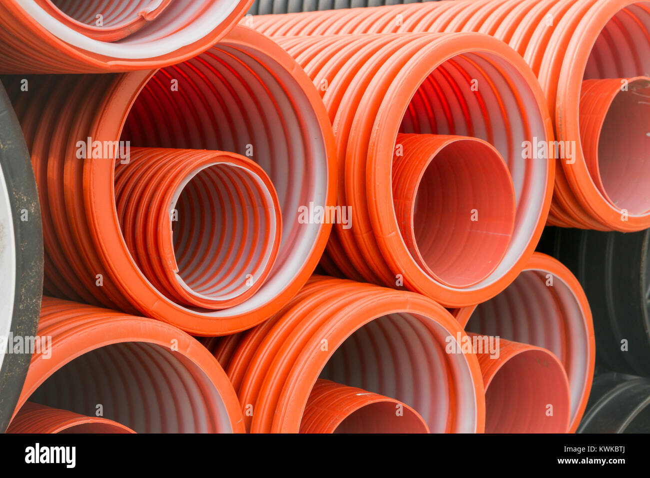 Construction orange and black plastic pipes Stock Photo Alamy