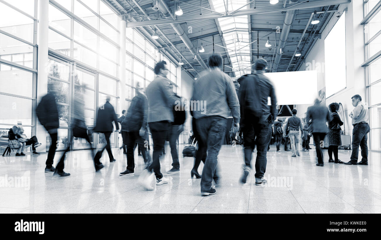 crowd of business people rushing in trade fair hall. Stock Photo