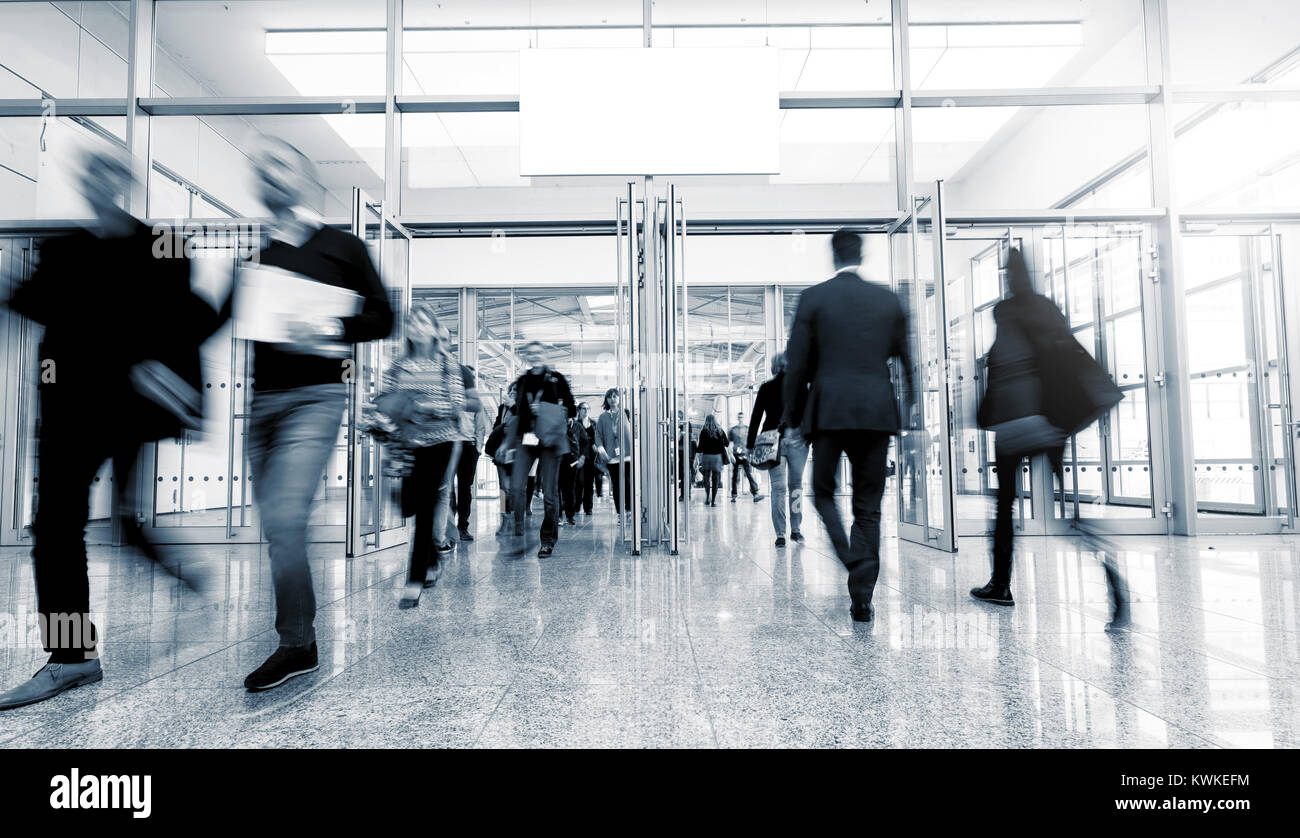business people rushing in a entrance at a trade show. Stock Photo